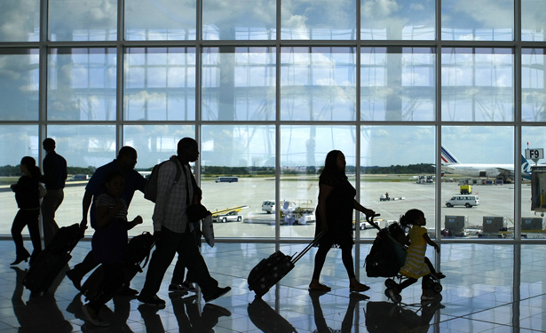Passengers walk through airport.